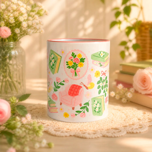 Taza literaria sublimada de cerámica 11 oz Jardín de Lectura con diseño delicado de flores, libros, sillón de lectura, taza de té y detalles rosados.