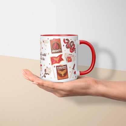 Taza sublimada de cerámica 11 oz Sinsajo, inspirada en Los Juegos del Hambre, con asa e interior rojo, arco, flecha, símbolos de rebelión y detalles rojos.