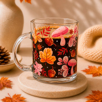 Taza de vidrio transparente 340 ml con diseño DTF UV de hojas otoñales, bellotas, hongos y flores en tonos naranjos y rosados.