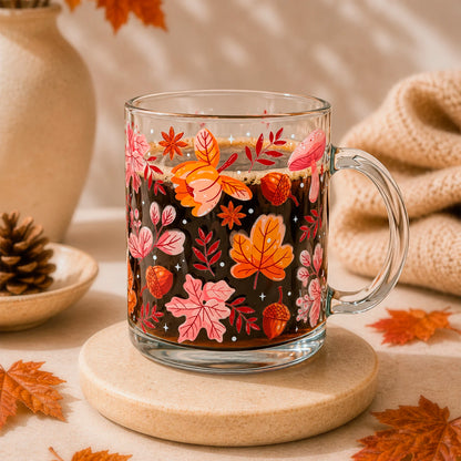 Taza de vidrio transparente 340 ml con diseño DTF UV de hojas otoñales, bellotas, hongos y flores en tonos naranjos y rosados.